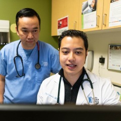 Two Doctors Collaborating Tells Patients They Have A Team Of Experts Caring For Them