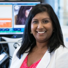 Smiling Minority Lab Technician Signals Warmth, Empathy, Ability To Connect With Patients