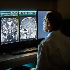 Experienced Radiologist Analyzing MRI Demonstrates Medical Imaging Technology Builds Trust