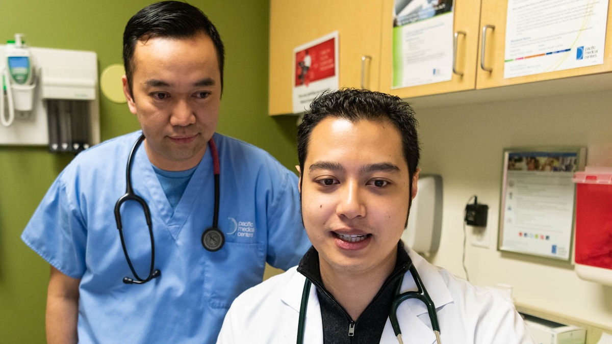 Two Doctors Collaborating Tells Patients They Have A Team Of Experts Caring For Them