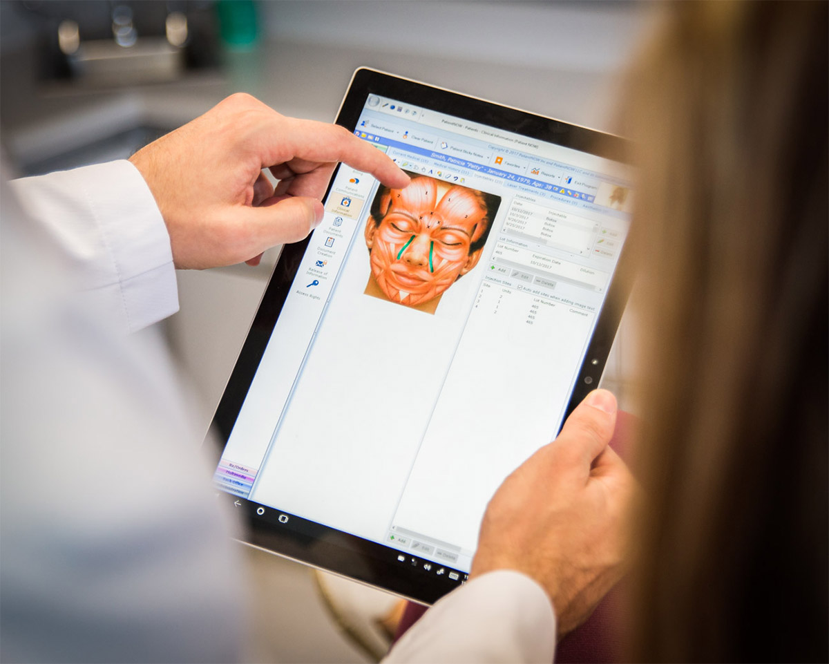 Seattle doctor reviewing surgical plans on an iPad with patient